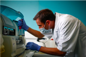 A technician scanning test tubes containing live samples of the coronavirus at the Robert Ballanger hospital near Paris on April 30.